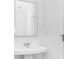 Stylish bathroom featuring a sleek pedestal sink, modern faucet, and a large, minimalist mirror at 209 Groveton Ct, Euharlee, GA 30145