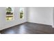 Bright bedroom features two windows and laminate floors at 209 Groveton Ct, Euharlee, GA 30145