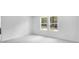 Bedroom featuring neutral carpeting and windows, perfect for rest and relaxation at 209 Groveton Ct, Euharlee, GA 30145