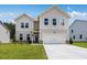 Charming two-story home with a well-manicured lawn and a two-car garage at 209 Groveton Ct, Euharlee, GA 30145