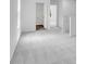 Bright hallway featuring neutral carpeting and a view of a closet and another room at 209 Groveton Ct, Euharlee, GA 30145