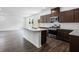 Spacious kitchen featuring stainless steel appliances, granite counters and island sink at 209 Groveton Ct, Euharlee, GA 30145