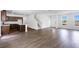 Spacious open-concept living room leading to a kitchen, featuring hardwood flooring throughout the main living areas at 209 Groveton Ct, Euharlee, GA 30145