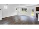 Bright living room featuring hardwood floors, white walls, and large windows offering a scenic outdoor view at 209 Groveton Ct, Euharlee, GA 30145