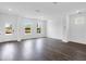 Large living room with hardwood flooring and two windows at 209 Groveton Ct, Euharlee, GA 30145