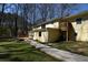 Expansive backyard featuring a wooden walkway, a deck, and mature trees providing ample shade and privacy at 2892 Cardinal Lake Dr, Duluth, GA 30096