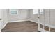 Bedroom area with modern floors, white trim, and French doors to another room at 2892 Cardinal Lake Dr, Duluth, GA 30096