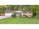 Charming ranch-style home with an attached garage and a well-maintained front lawn and mature trees at 2892 Cardinal Lake Dr, Duluth, GA 30096