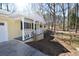 Side view of charming front porch with white trim and yellow exterior at 2892 Cardinal Lake Dr, Duluth, GA 30096
