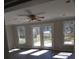 Bright living room featuring a ceiling fan, hardwood floors, and access to the deck at 2892 Cardinal Lake Dr, Duluth, GA 30096