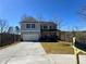 Two-story home with a gray exterior, dark shutters, a covered front porch, and a freshly laid driveway at 5342 Legacy Trl, Douglasville, GA 30135