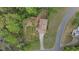 Aerial view of a house featuring a driveway, yard, mature trees, and a fenced in yard at 700 Bayliss Dr, Marietta, GA 30068