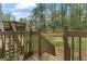 Back yard featuring multiple decks, fenced in yard, mature trees for privacy, and a lush green lawn at 700 Bayliss Dr, Marietta, GA 30068