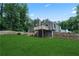View of the backyard and a wooden deck with stairs leading to the grassy lawn at 700 Bayliss Dr, Marietta, GA 30068