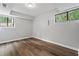 A finished basement room with a window view of the outdoors and hardwood floors at 700 Bayliss Dr, Marietta, GA 30068