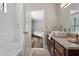 Bright bathroom featuring a shower and marble vanity with dark wood cabinets at 700 Bayliss Dr, Marietta, GA 30068