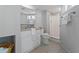 Updated bathroom with a glass enclosed shower, updated vanity, tile floors, and decorator mirror at 700 Bayliss Dr, Marietta, GA 30068