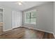 Bedroom featuring wood flooring, window, and spacious closet at 700 Bayliss Dr, Marietta, GA 30068