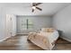 Bright bedroom with hardwood floors and a cozy bed, bathed in natural light at 700 Bayliss Dr, Marietta, GA 30068