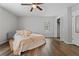 Brightly lit bedroom with a ceiling fan, closet, and plush bedding at 700 Bayliss Dr, Marietta, GA 30068