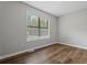 Neutral bedroom with wood floors, a large window, and natural lighting at 700 Bayliss Dr, Marietta, GA 30068