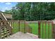 A wooden deck with stairs and railings overlooking a large, well-maintained backyard at 700 Bayliss Dr, Marietta, GA 30068