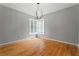 Bright dining room featuring hardwood floors, a corner window, and a modern light fixture at 700 Bayliss Dr, Marietta, GA 30068