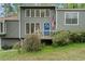 View of the home's entrance featuring a blue door decorated with a wreath and an American flag at 700 Bayliss Dr, Marietta, GA 30068