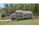 Charming home featuring a front yard, a wooden fence, and a blue door with an American flag at 700 Bayliss Dr, Marietta, GA 30068