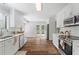 Bright kitchen featuring white cabinets, stainless steel appliances, and modern countertops at 700 Bayliss Dr, Marietta, GA 30068
