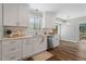 Bright kitchen featuring white cabinets, stainless steel appliances, and hardwood floor at 700 Bayliss Dr, Marietta, GA 30068
