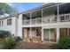 View of the back of the home with a private covered balcony and an access patio at 73 Rumson Se Ct, Smyrna, GA 30080