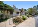 Charming building with manicured landscaping, a stone chimney, and a stone accent wall at 73 Rumson Se Ct, Smyrna, GA 30080