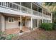Exterior of the home featuring a private balcony and enclosed outdoor patio at 73 Rumson Se Ct, Smyrna, GA 30080