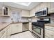 Updated kitchen featuring granite counters, white cabinets, and stainless steel appliances at 73 Rumson Se Ct, Smyrna, GA 30080