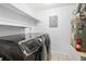 Functional laundry room featuring modern appliances, shelving, and tiled floors for convenience at 73 Rumson Se Ct, Smyrna, GA 30080