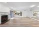Open-concept living space featuring fireplace, hardwood floors, and mirrored wall at 73 Rumson Se Ct, Smyrna, GA 30080