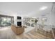 Bright living room with fireplace and tan sofas, adjacent to dining area at 73 Rumson Se Ct, Smyrna, GA 30080