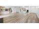 Open-concept living area showcasing hardwood floors, mirrored wall, and a view of the kitchen at 73 Rumson Se Ct, Smyrna, GA 30080