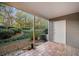 Cozy patio area featuring brick flooring, an access door, and view of mature landscaping at 73 Rumson Se Ct, Smyrna, GA 30080
