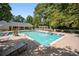 Community swimming pool surrounded by lounge chairs and landscaping, perfect for relaxation at 73 Rumson Se Ct, Smyrna, GA 30080