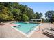 Community swimming pool with lounge chairs, brick patio, and inviting clear water at 73 Rumson Se Ct, Smyrna, GA 30080
