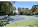Well-maintained tennis courts surrounded by lush greenery for a private experience at 73 Rumson Se Ct, Smyrna, GA 30080