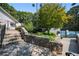 Entrance to tennis courts with stone wall, landscaping, and signage at 73 Rumson Se Ct, Smyrna, GA 30080