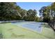 Dual tennis courts surrounded by mature trees providing shade and a sense of privacy at 73 Rumson Se Ct, Smyrna, GA 30080