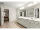 Elegant bathroom with double vanity and ample cabinet space, leading to adjoining bedrooms and closets at 1119 Brownstone Dr, Marietta, GA 30008