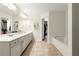 Spacious bathroom with double vanity, soaking tub, and walk-in closet, offering a luxurious and organized space at 1119 Brownstone Dr, Marietta, GA 30008