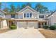 Inviting townhome featuring a two-car garage and charming curb appeal at 1119 Brownstone Dr, Marietta, GA 30008