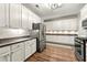 Updated kitchen featuring stainless steel appliances, granite countertops, and ample storage space with white cabinetry at 1119 Brownstone Dr, Marietta, GA 30008