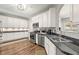Modern kitchen features stainless steel appliances, granite countertops, and ample storage space in stylish white cabinetry at 1119 Brownstone Dr, Marietta, GA 30008
